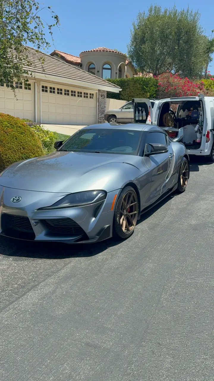 Grey Toyota Supra in a driveway after detailing